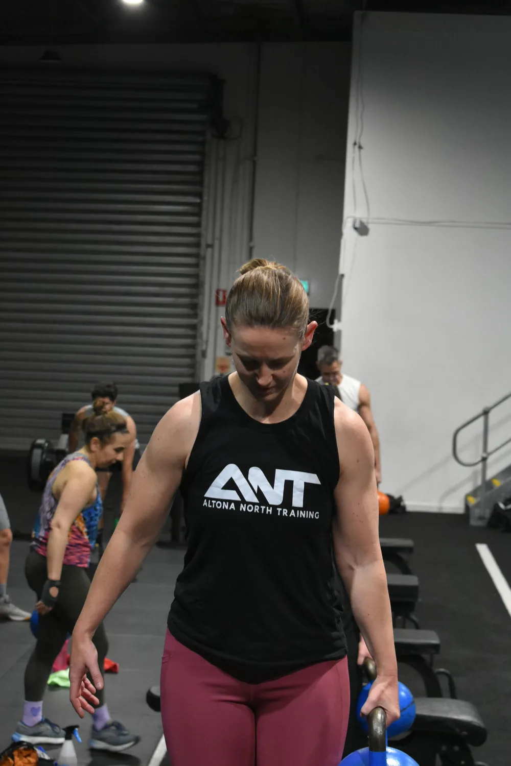 Member in an ANT tank top on the gym floor