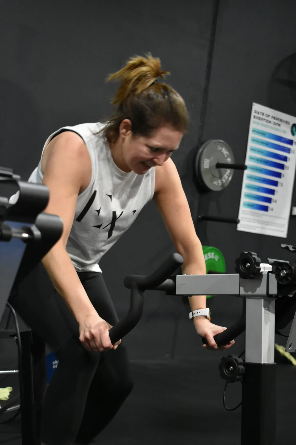 Member riding the air bike during a conditioning session