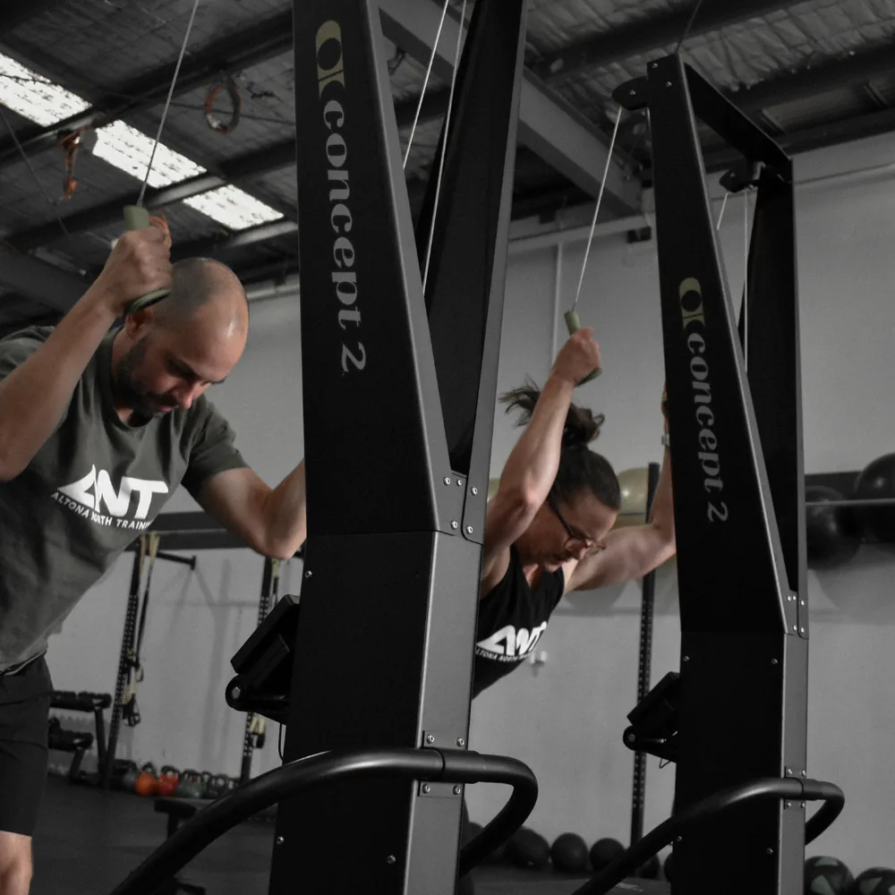 Coach and member on the ski ergs