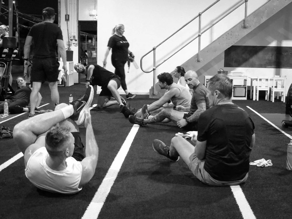 Group of members finishing a session on the gym floor