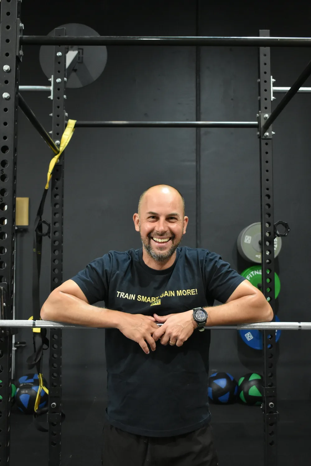 Gabriel Leutz, founder of Altona North Training, leaning on a barbell