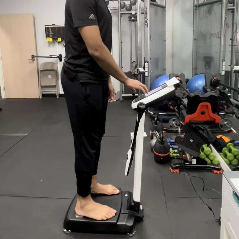 Member standing on the InBody 270 body composition scanner