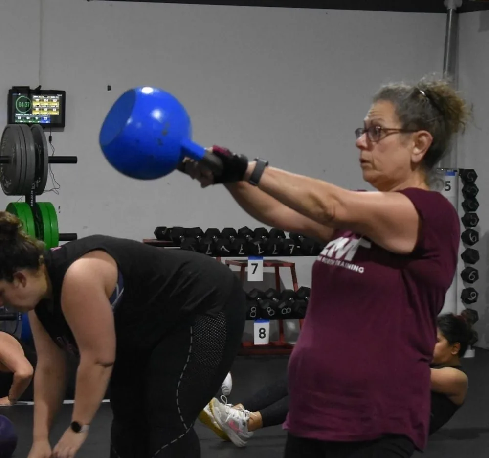 Member swinging a kettlebell