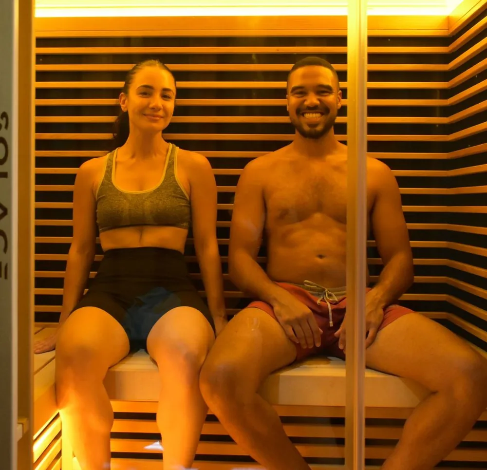 Two members relaxing in the Breather infrared sauna