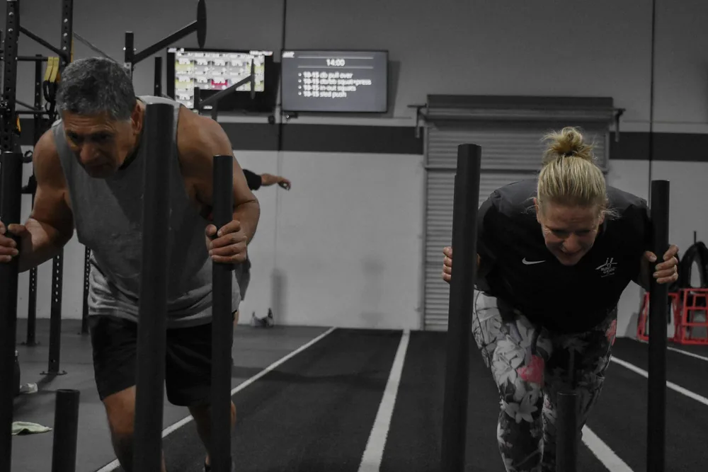 Members pushing sleds